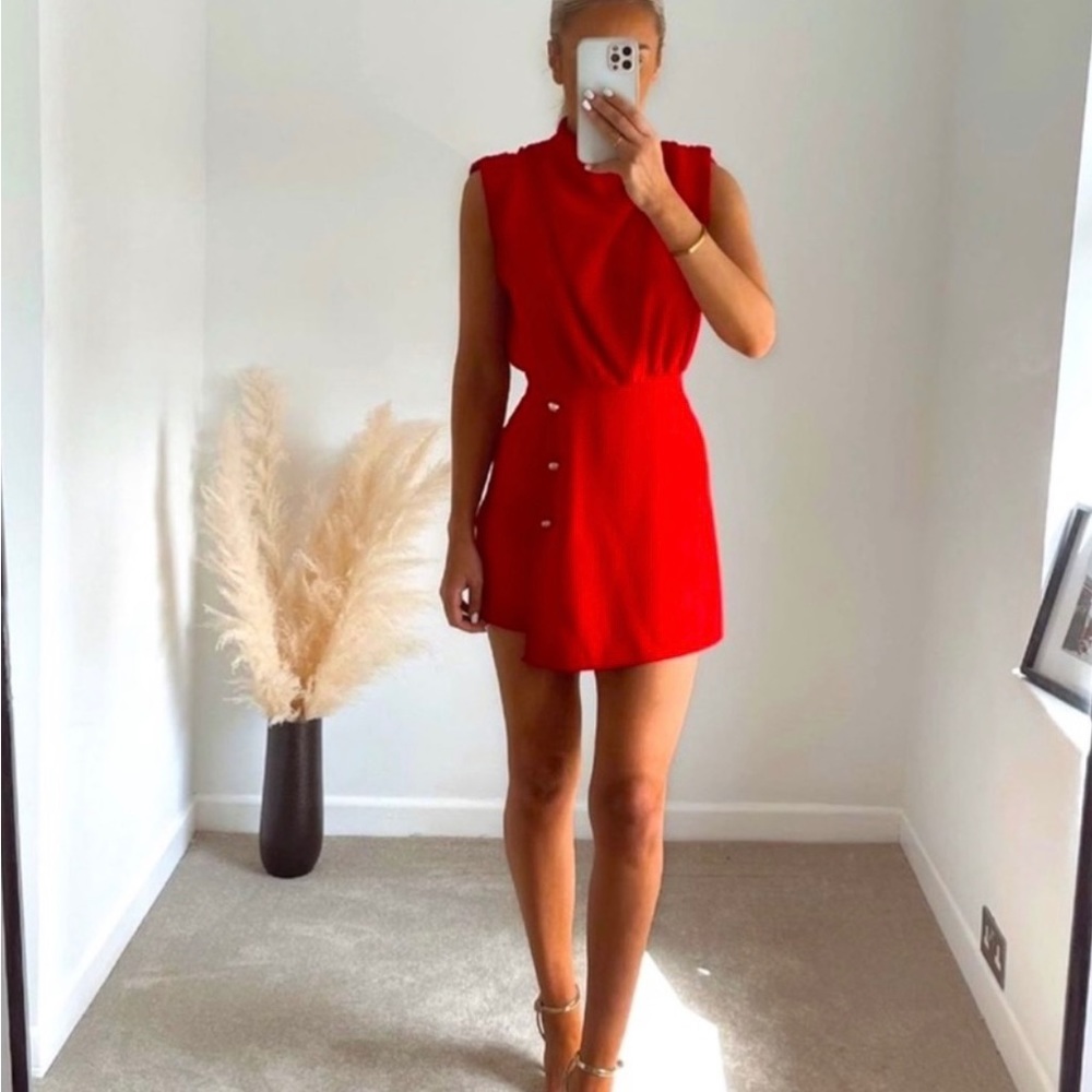 Short sleeveless romper with high collar. Brand new with tags.